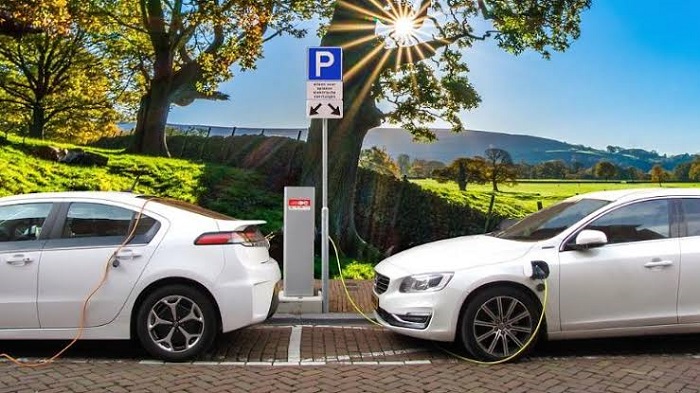 Image Showing Electric Vehicle During Charging In The Street Station.