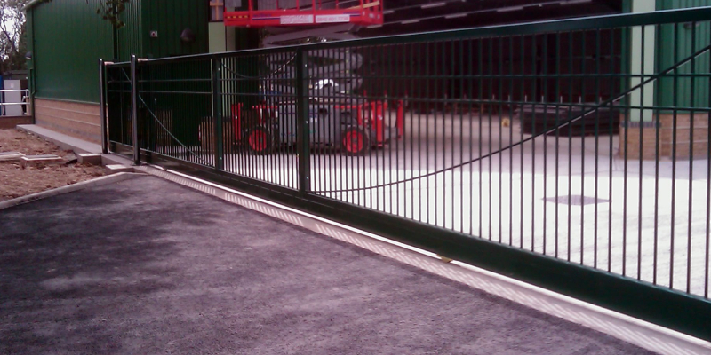 Neatly designed long sliding gate in front of a factory.